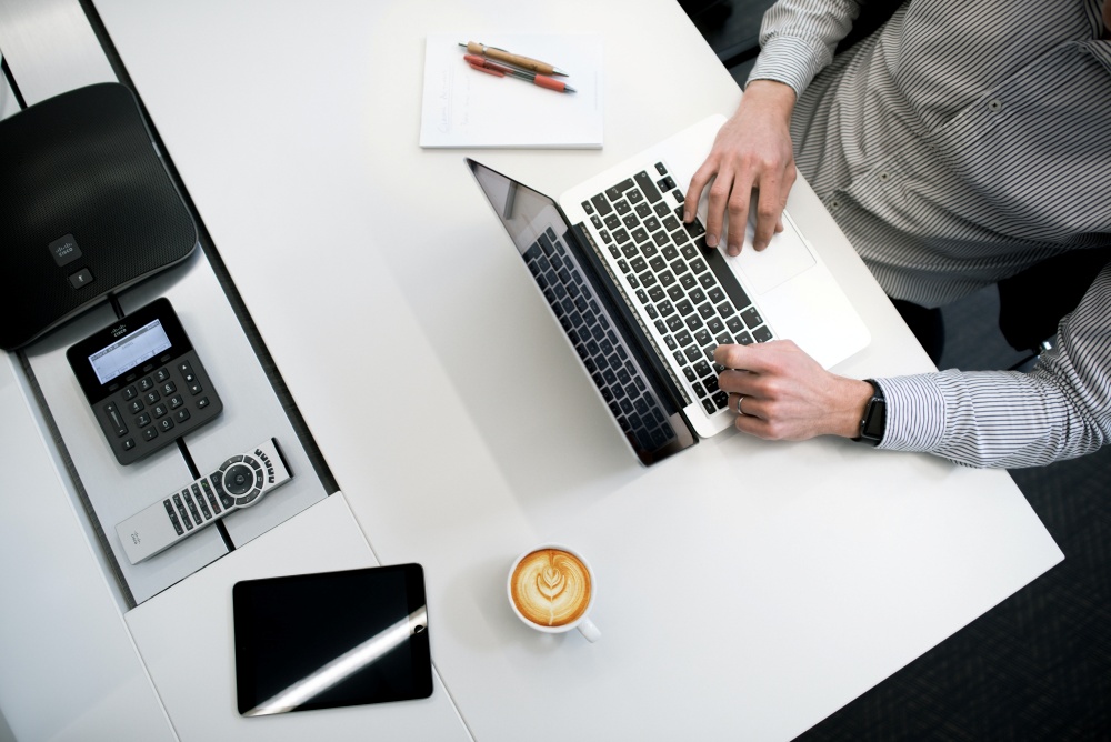 man on desk using laptop